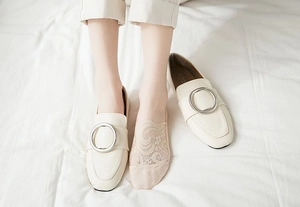 Detail of female loafer with metal ring buckle and floral lace low cut liner sock