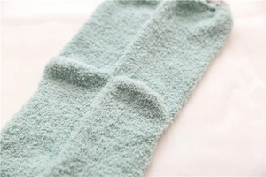 Close-up of soft mint green coral fleece texture on thick thermal crew socks