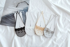Detail of lace floral embroidery on breathable mesh no-show socks in four assorted colors