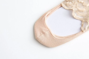 Detail of nude invisible lace boat sock featuring intricate floral embroidery and mesh