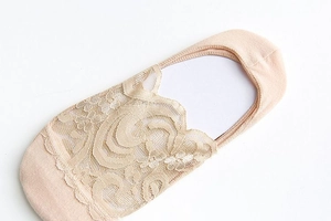 Detailed close-up of beige floral lace invisible boat socks with scalloped edges