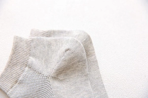 Close-up detail of grey cotton mesh sock heel featuring premium ribbed knitting craftsmanship