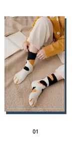 Close-up of cat paw thermal coral fleece socks with three-color plush pattern design