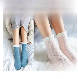 Detail of coral fleece winter socks in blue and pink with soft white fuzzy trim