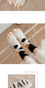 Detail of coral fleece cat claw socks with thick thermal fabric and embroidered paw patterns