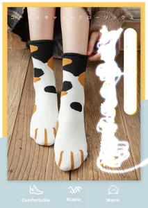 Close-up of cozy cat paw thermal socks worn on wood floor for home warmth