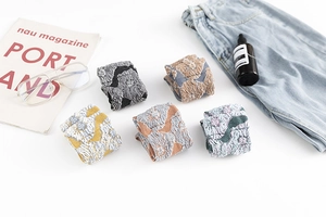 Flat lay of five pairs of vintage floral cotton socks in various retro patterns and colors