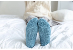 Detail of soft Morandi blue coral fleece socks for winter comfort and warmth