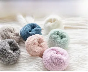 Detailed texture of thick coral fleece socks in soft pastel macaron colors for winter