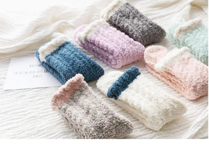 Detailed view of colorful coral fleece thermal socks with soft plush thickened cuffs