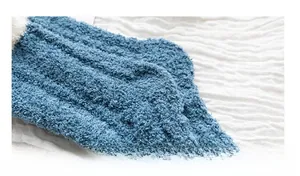 Close-up of thick blue coral fleece fabric showing soft texture of thermal winter socks