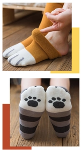 Detailed view of thick cat paw socks featuring cozy fleece lining and cute paw print pads