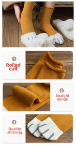 Macro detail of ginger knit cotton cat claw socks with rolled cuffs and smooth toe seam