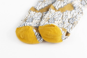 Detailed close-up of retro floral jacquard weave on thick cotton socks toes