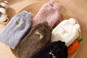 Close-up of five pairs of thick coral fleece winter socks with cat face embroidery