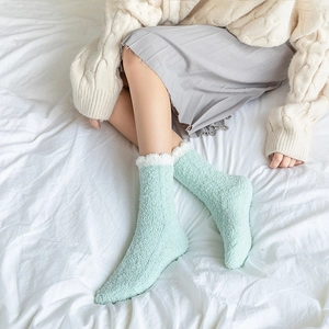Soft mint green coral fleece house socks with white faux fur trim for warm winter comfort
