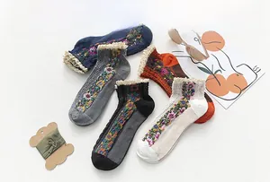 Flat lay of vintage floral cotton socks with delicate lace trim and cable knit texture