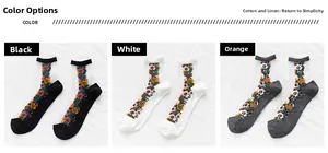 Détail de broderie florale sur chaussettes en tulle transparent noir, blanc et beige