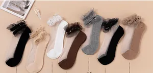 Flat lay of sheer lace socks in seven colors including beige, black and blue mesh styles