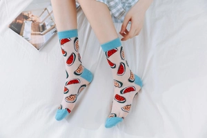 Detail of transparent mesh crew socks featuring light blue trim and watermelon patterns