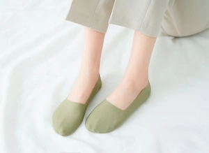 Detail of olive green seamless ice silk no-show socks with smooth cut edges on foot