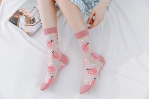 Detail of sheer mesh socks with pink peach patterns and reinforced cotton heels