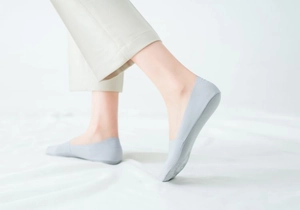 Detail of light gray seamless ice silk invisible socks worn with a smooth cut edge