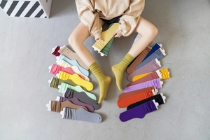 Detailed top view of various colorful velvet slouch socks in over twenty vibrant shades