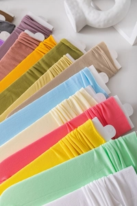 Close-up of colorful ribbed velvet slouch socks on cards in vibrant candy colors