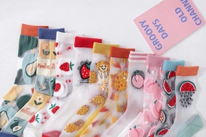 Flat lay of sheer glass silk crew socks featuring colorful cartoon fruit and floral patterns
