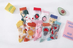 Detail of transparent mesh socks featuring colorful cartoon fruit patterns and ribbed cuffs