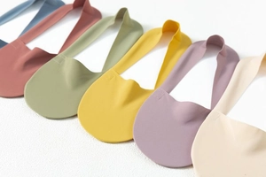 Flat lay of seamless ice silk bras in six Morandi colors including blue and brick red