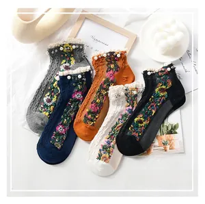 Detail of five-pair cotton socks set with lace edges, pearls and vintage flower patterns