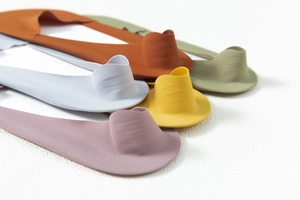 Detail of five assorted seamless invisible boat socks in various colors on white background
