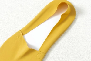 Detail of yellow seamless ice silk fabric with smooth laser-cut edges and elastic texture