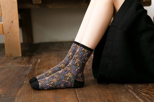 Close-up of vintage floral jacquard pattern and knit texture on autumn crew socks