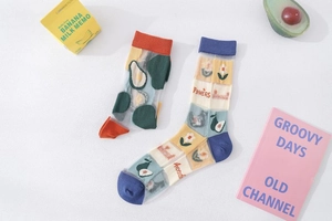 Close-up of sheer mesh socks with avocado patterns and daisy floral embroidery