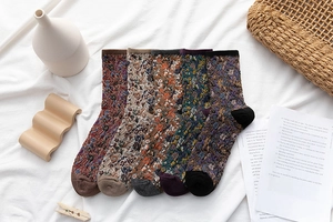 Close-up of five pairs of vintage floral knit socks with 3D embossed texture and patterns
