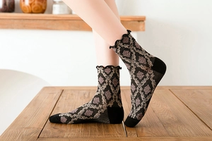 Detail of vintage retro mid-calf socks with jacquard pattern and ruffled lettuce edges