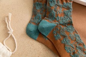 Macro shot of 3D embossed floral patterns on retro caramel cotton blend crew socks