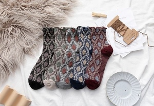 Detailed view of five pairs of vintage floral knit crew socks with ruffled cuffs