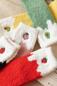 Detail of soft winter coral fleece socks with cute fruit embroidery in various colors