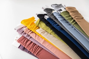 Close-up of colorful ribbed slouch socks in 10 vibrant colors with premium packaging
