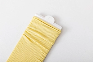 Detail of bright yellow ribbed velvet knee high socks with professional hanging card display