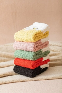 Close-up of fluffy colorful fleece socks in yellow pink green red and black tones