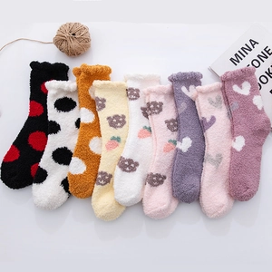 Detailed view of cozy coral fleece socks with cute bear patterns and heart prints
