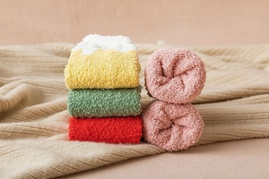 Detailed view of thick winter cartoon coral fleece socks in assorted warm colors