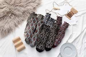 Close-up of retro cotton socks with diamond texture and elegant ruffle trim details