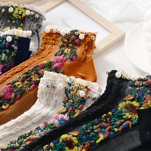 Floral knit socks with lace ruffle trim and pearl accents in assorted vintage colors
