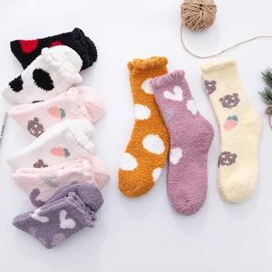 Detail showing thick coral fleece warm socks with cute bear patterns and strawberry embroidery